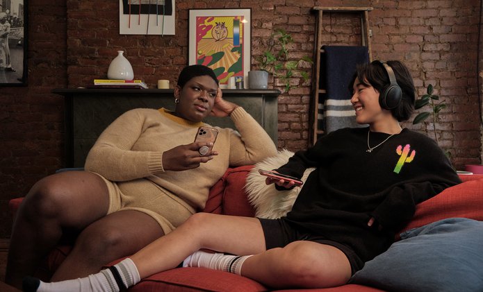 A non-binary trans woman and a non-binary person enjoying time on the couch.jpg