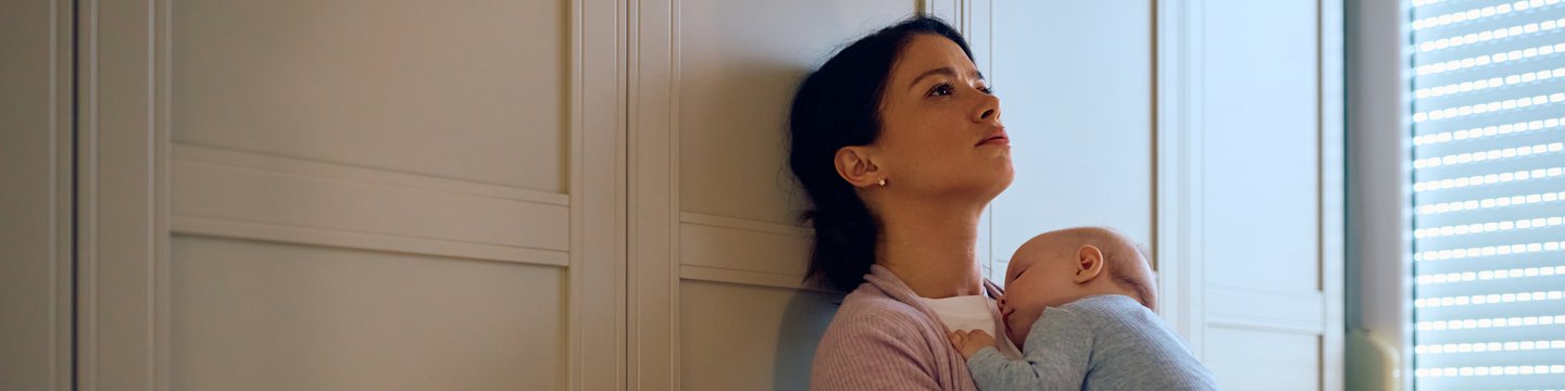 fed-up-woman-holding-baby.jpg