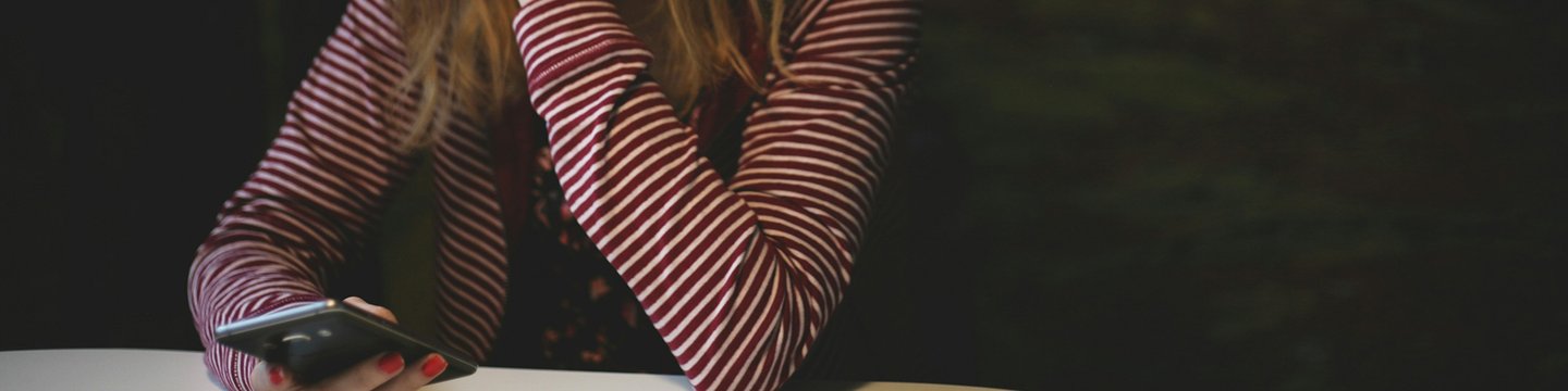 Safeguarding at Shout header image - young white woman texting - kev-costello-w3jVXGkYZCw-unsplash