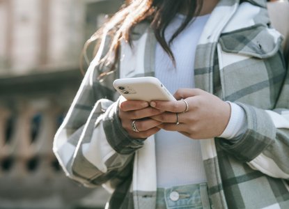 woman plaid jacket texting iphone.jpg