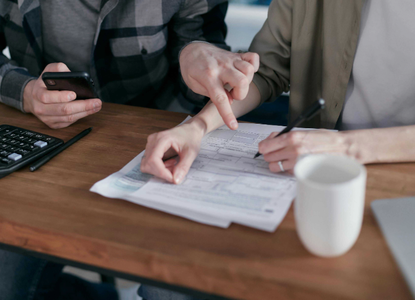 hands-of-two-people-filling-out-form.png