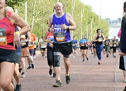 Adrian running Royal Parks Half in Shout vest.png