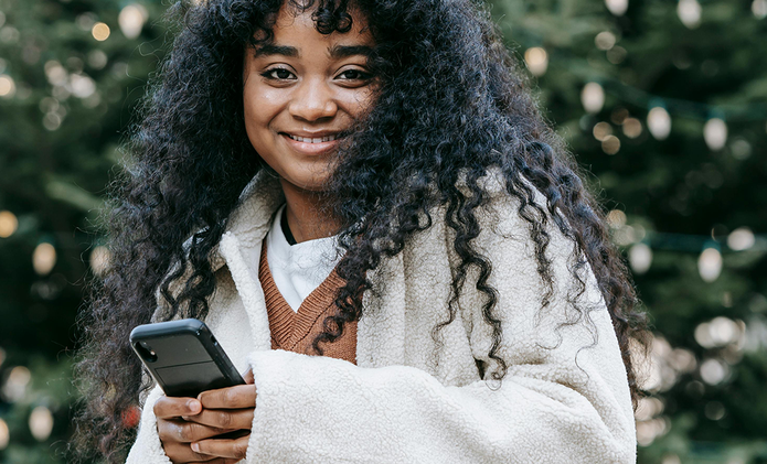 smiling-black-woman-with-phone-christmas.png