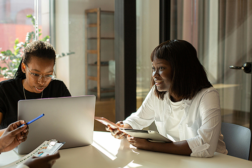 Twowomensmilingatwork.png