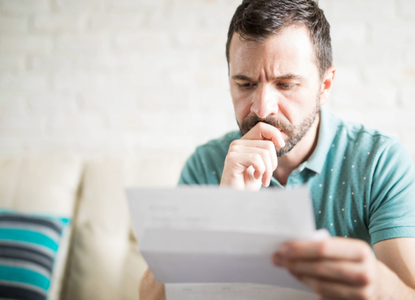 white-man-looks-worried-at-bill.jpg